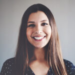 woman with long brown hair wearing a polka-dotted blouse