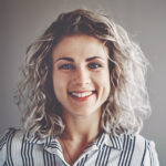woman with curly hair wearing a striped shirt
