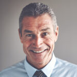 man in a blue shirt and polka dot tie