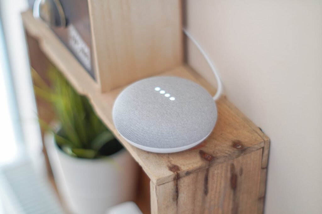 smart speaker on a wooden shelf