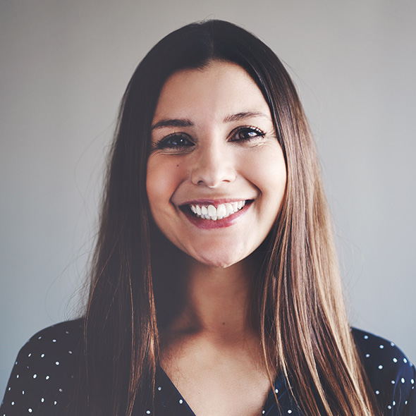 woman with long brown hair wearing a polka-dotted blouse