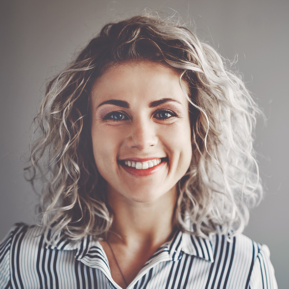 woman with curly hair wearing a striped shirt